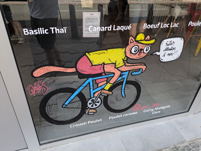 Cat on a bike shopfront illustration