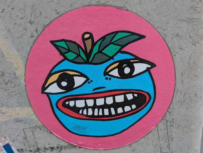 A slightly scary looking fruit character sticker