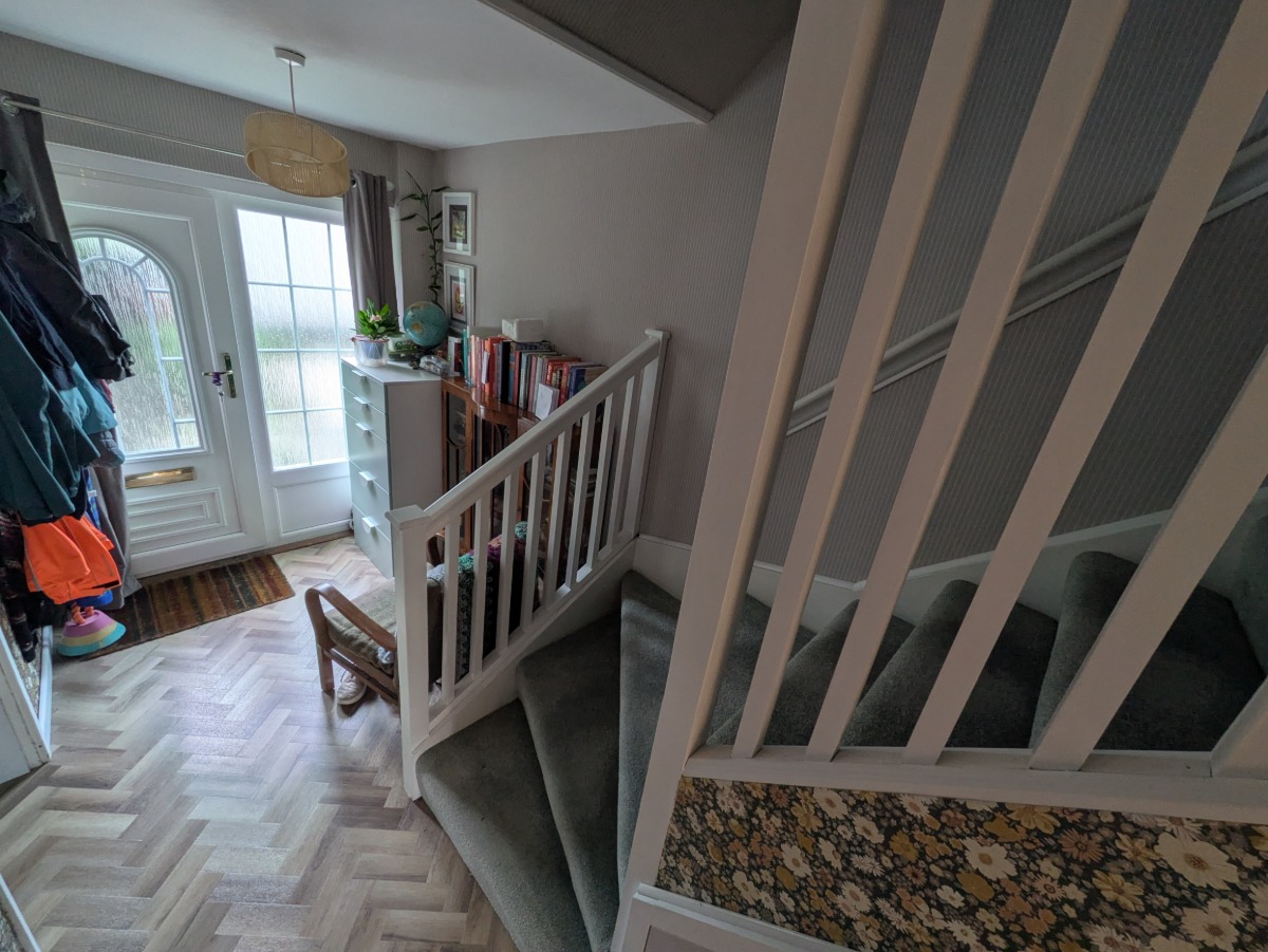A photograph of a hallway showing new wooden bannisters