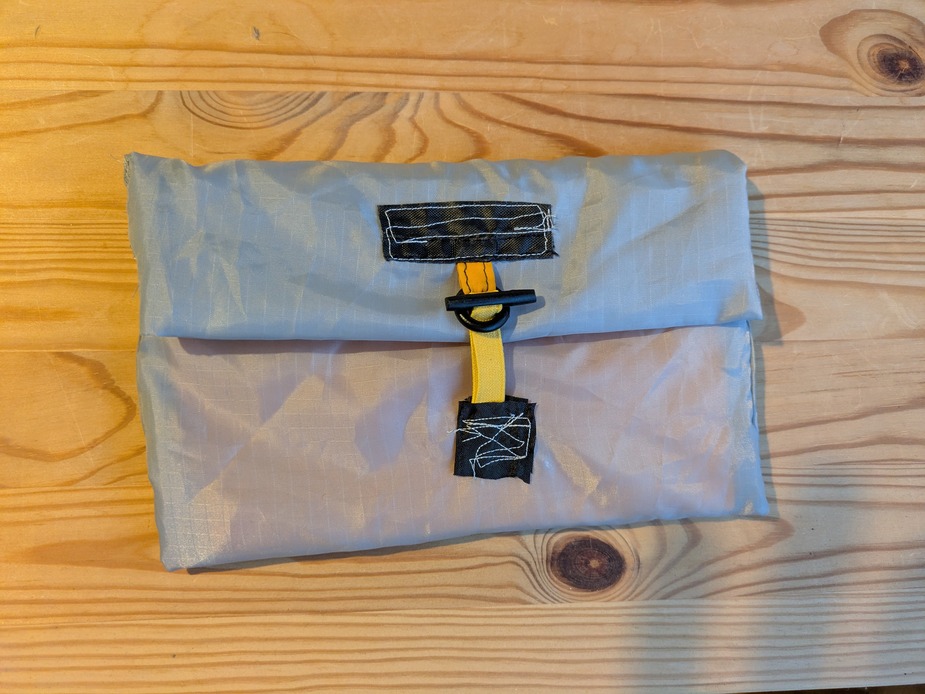 The exterior of a sewn notebookholder made from recycled tent inner material